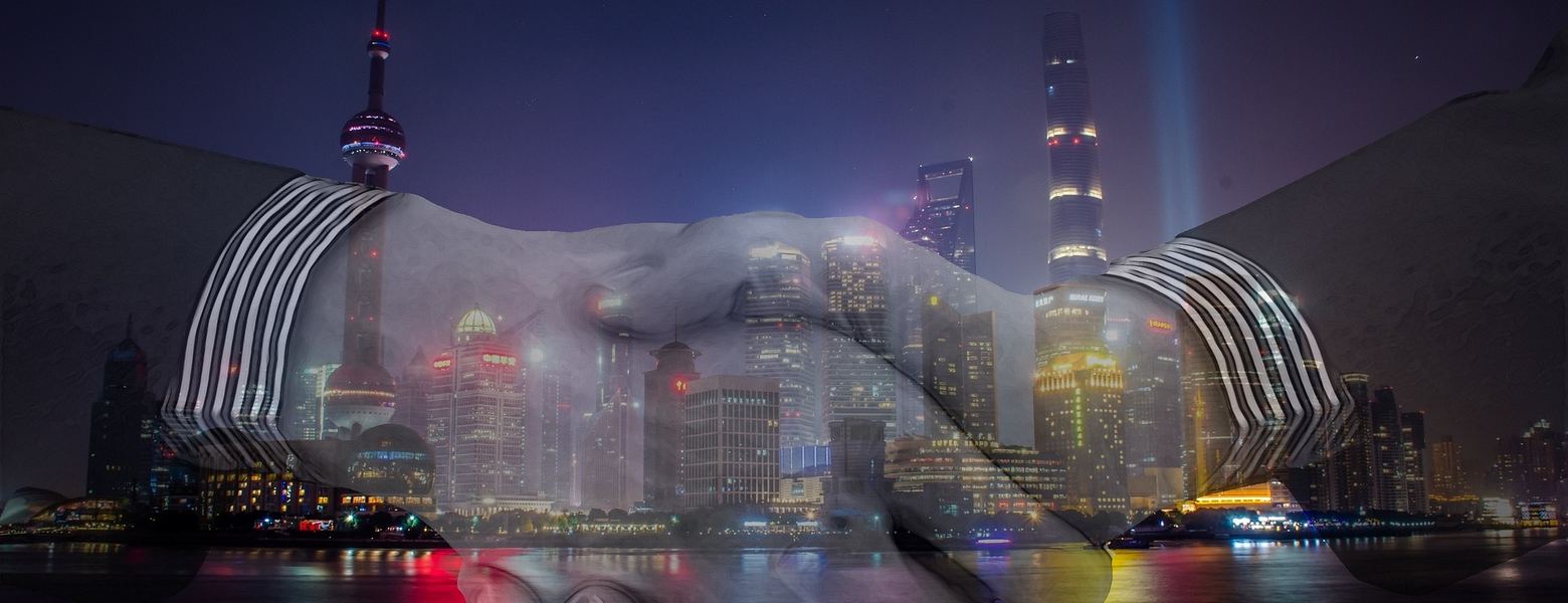 A handshake superimposed over two city skylines at night