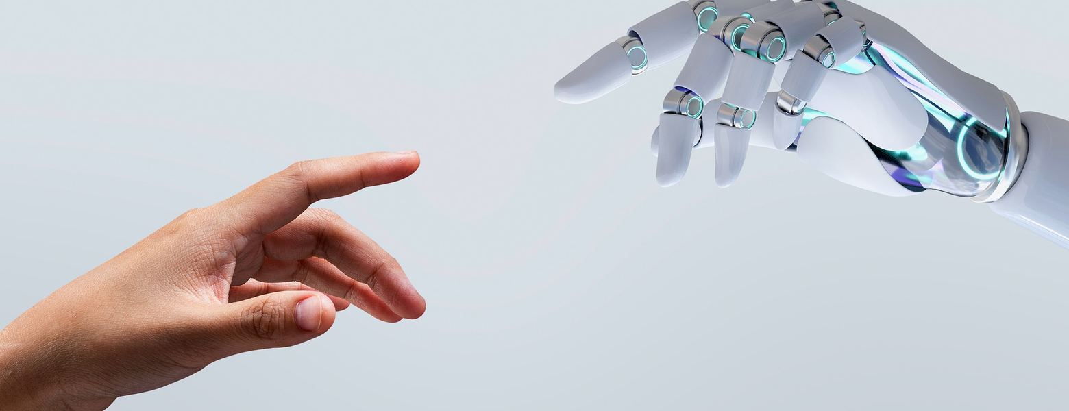 A human hand reaching toward a robotic hand
