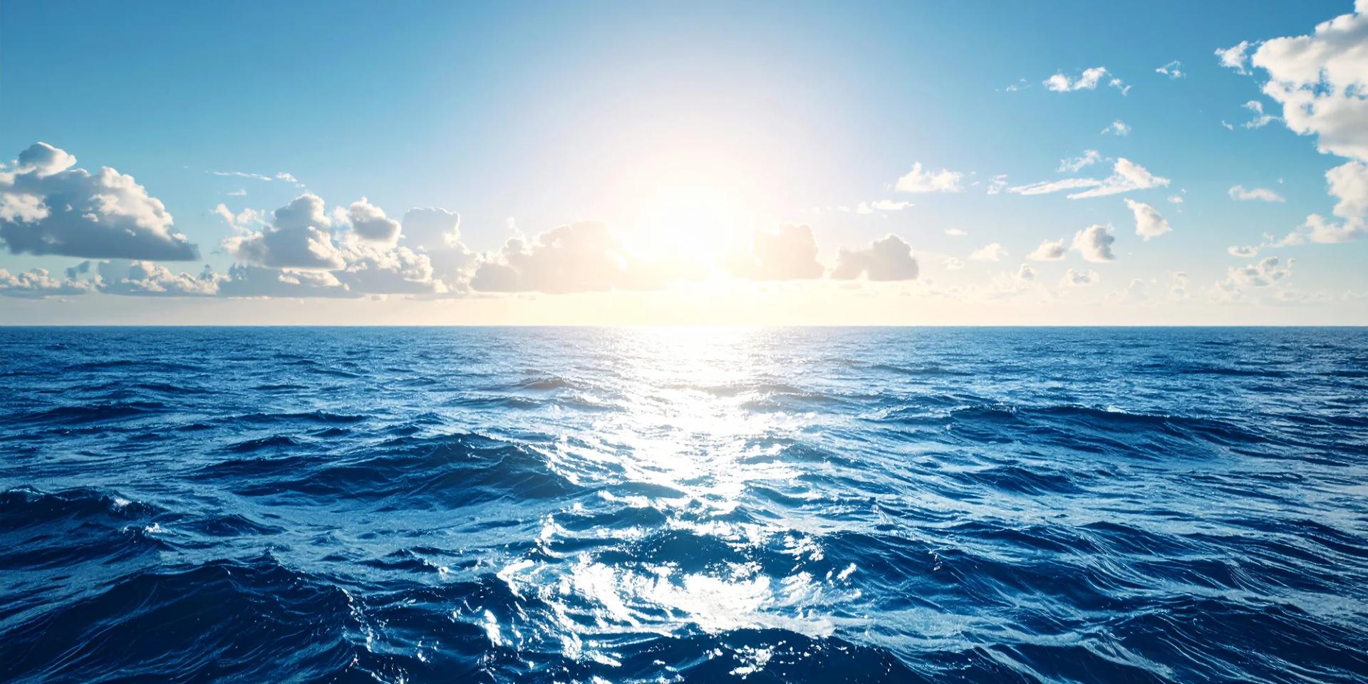 Sunlight reflecting across calm blue ocean water to the horizon