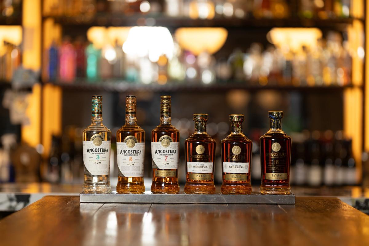 Six Angostura rums in a row on a bar tray: the 3, 5 and 7 year old rums, 1919, 1824 and 1787