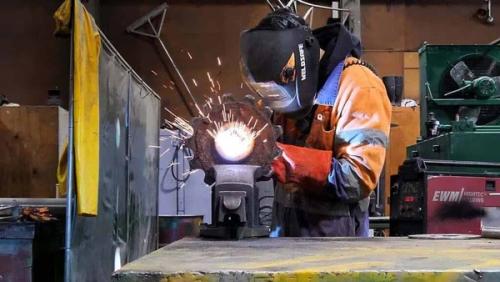 heavy fabrication apprentice working on a welding job in an engineering workshop