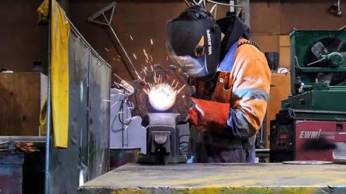 heavy fabrication apprentice working on a welding job in an engineering workshop