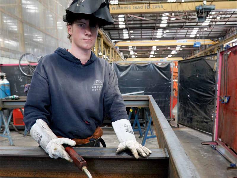Apprentice preparing structural steel in a South Auckland engineering workshop
