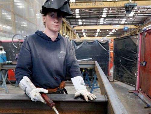Apprentice preparing structural steel in a South Auckland engineering workshop