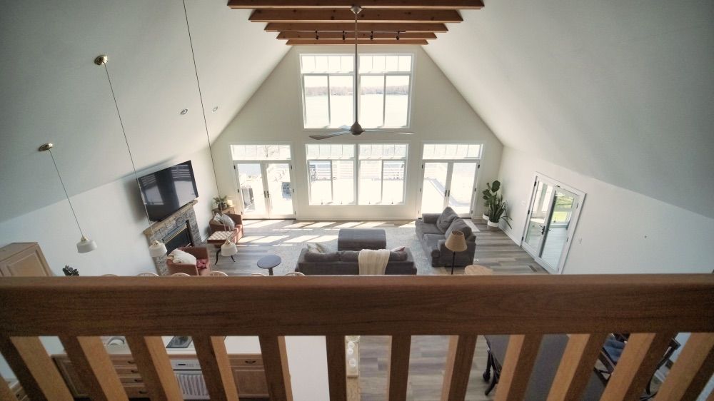 View from the loft looking down over the open great room and kitchen