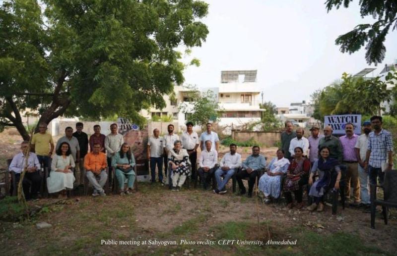 A group photo of people after the public meeting. 27 people are present in the photo.