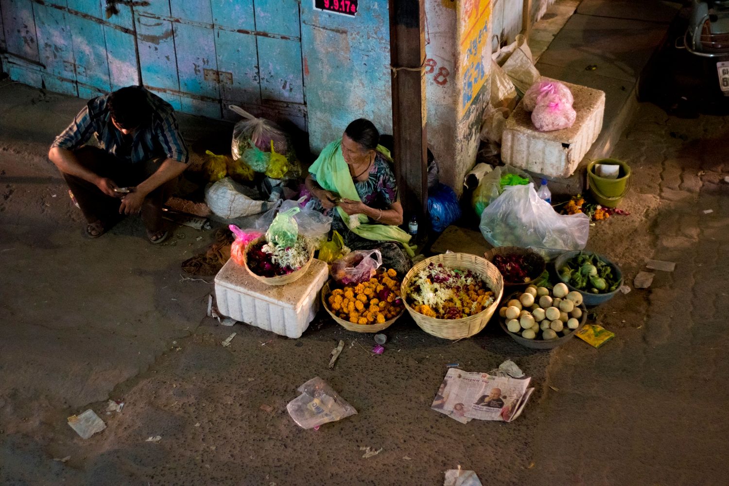 Aerial shot of a woman selling vegetables by the roadside.