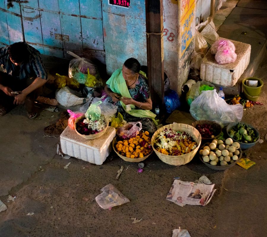Aerial shot of a woman selling vegetables by the roadside.