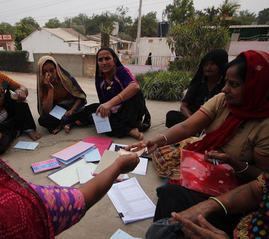 SHG members collecting money to give loans to other members in need