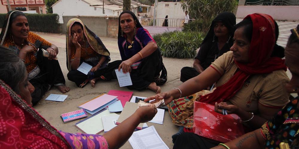 SHG members collecting money to give loans to other members in need