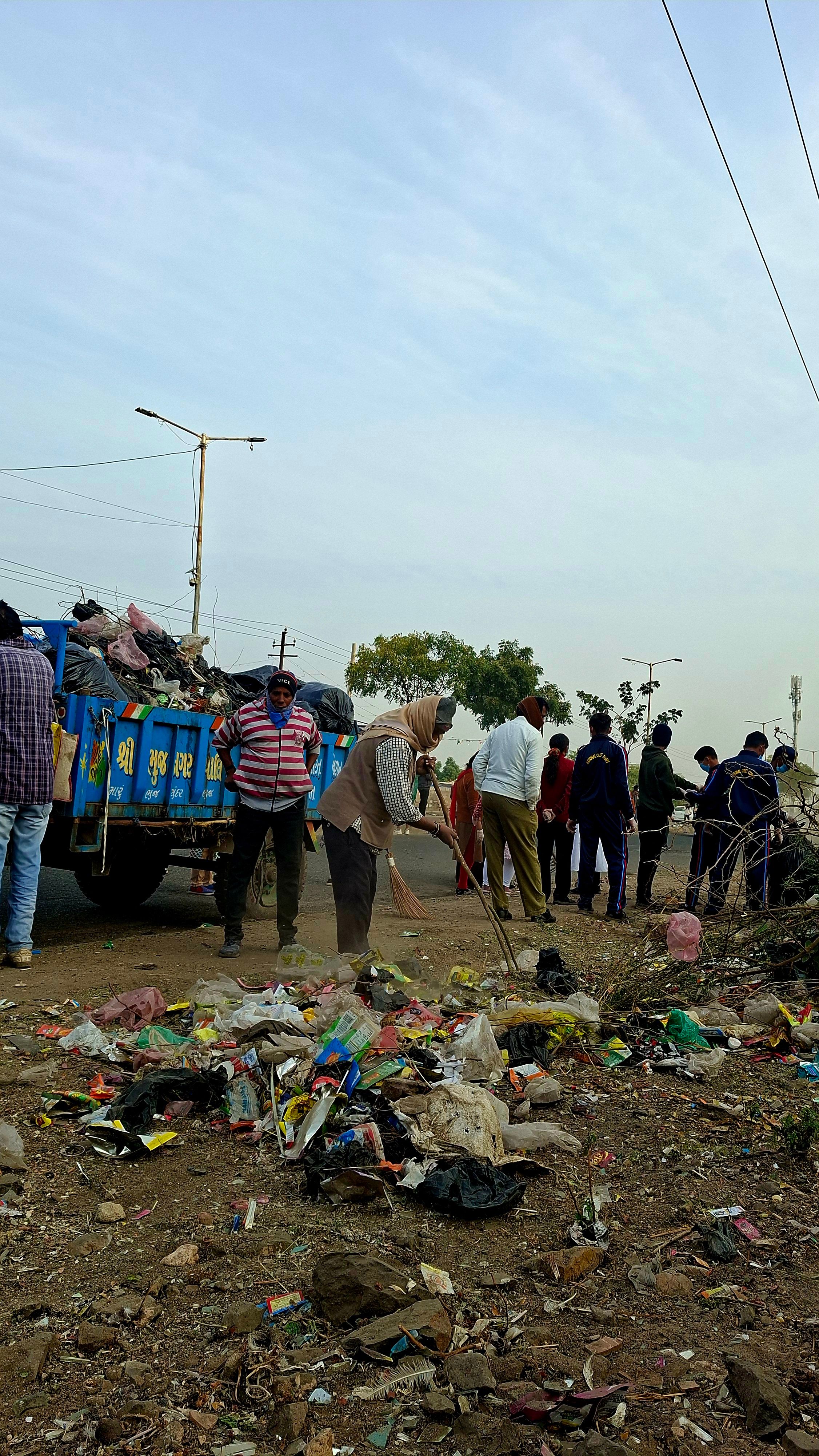 People cleaning a road side 