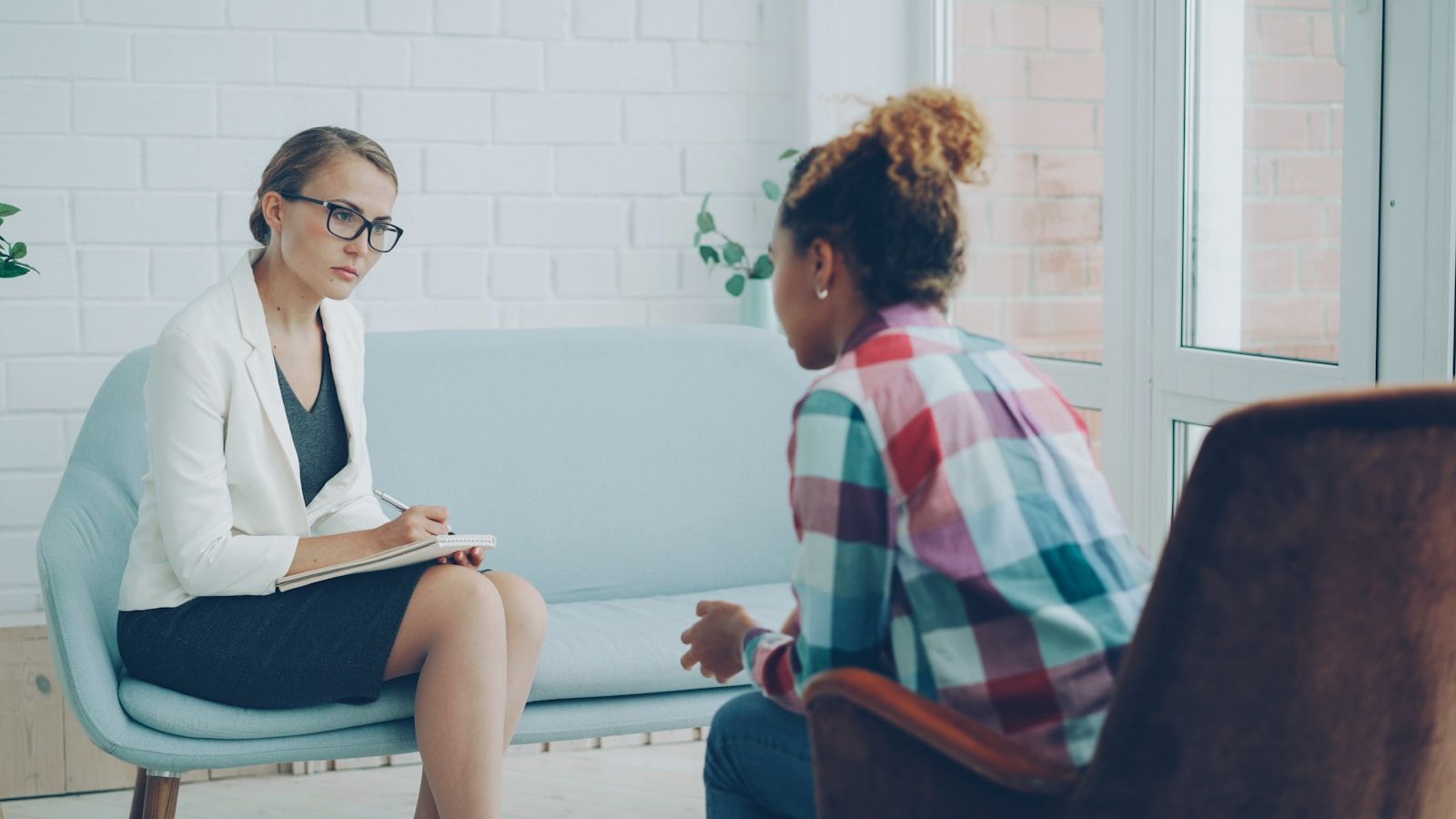 Calm one-to-one therapeutic conversation in a professional consultation setting
