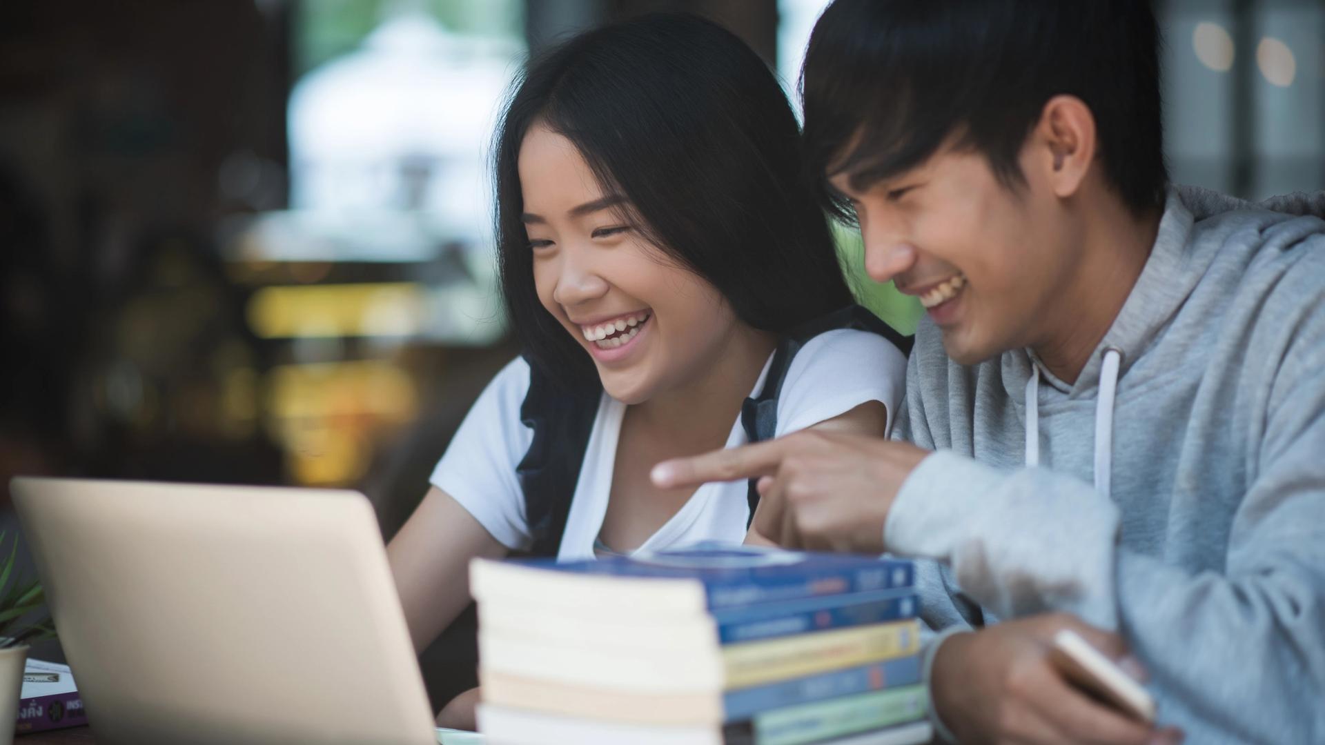 Parent helping a child follow a March holiday catch-up study plan at home in Singapore