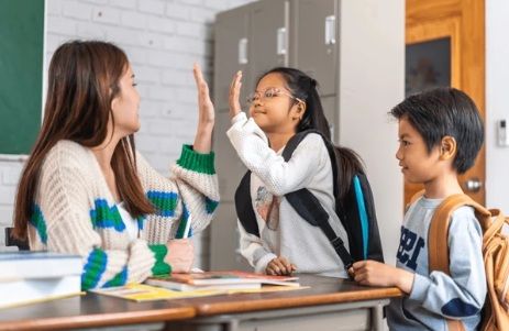 Secondary school students engaging positively with their teacher, showing confidence and support during the transition from Sec 3 to Sec 4.