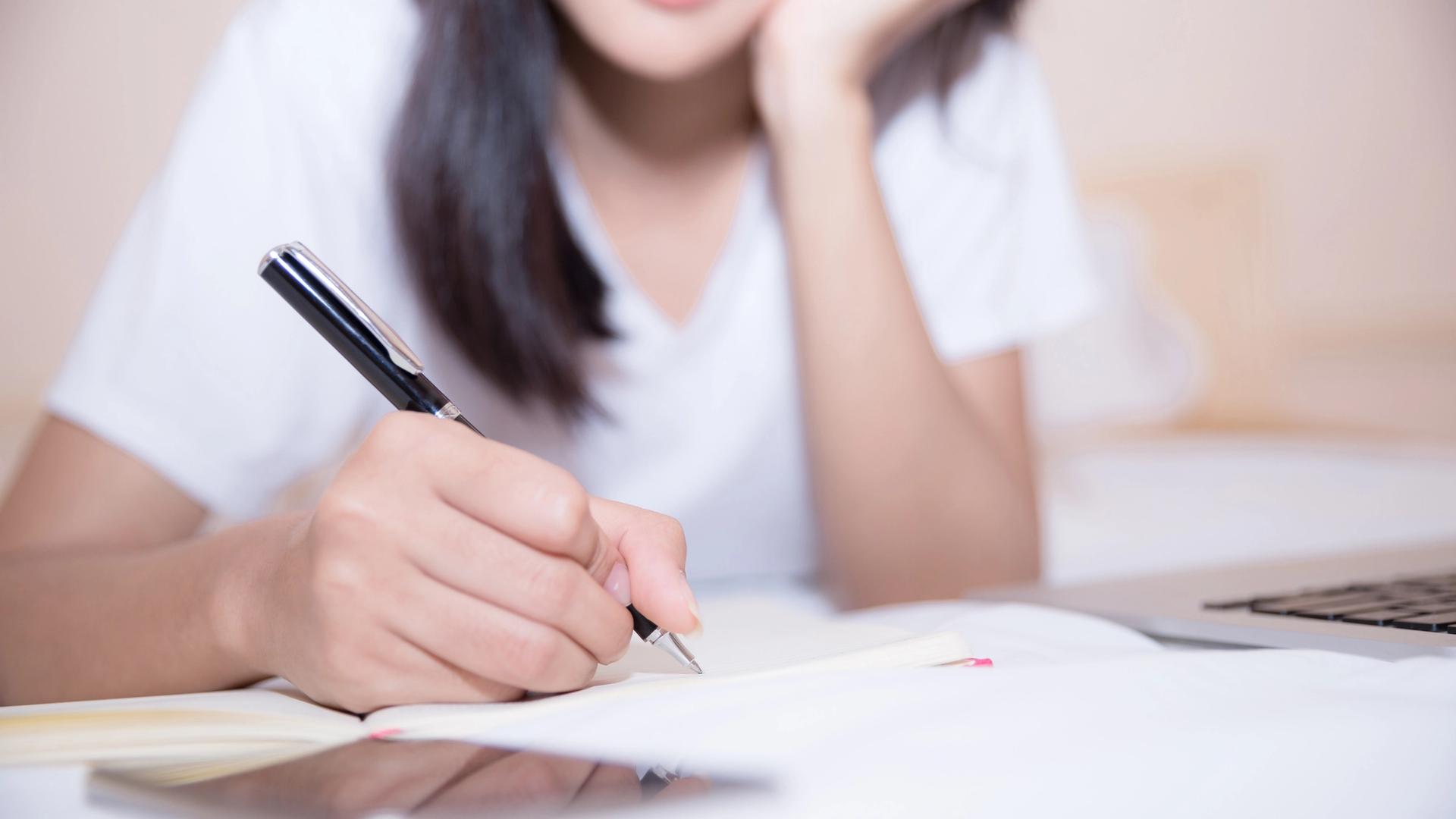 JC student reviewing GP application question strategies with notes and comprehension paper