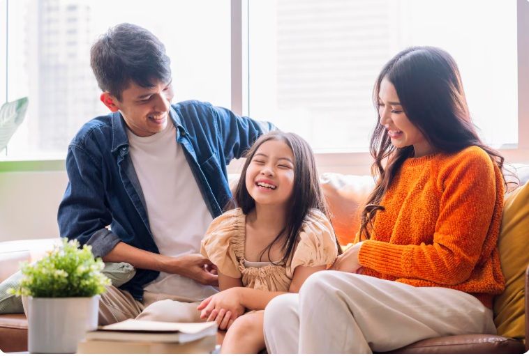 Singapore parents sitting with their child at home discussing school and exploring tutoring options