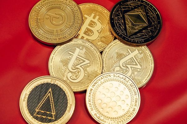 a pile of bitcoins sitting on top of a red cloth