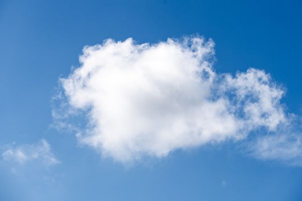 a white cloud in a blue sky