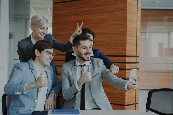 Colleagues taking a selfie in the office