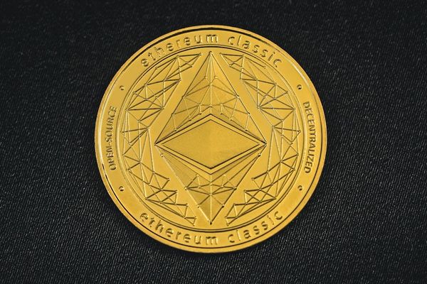 a close up of a coin on a black surface