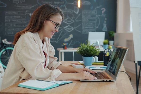 Young woman working on laptop in modern office