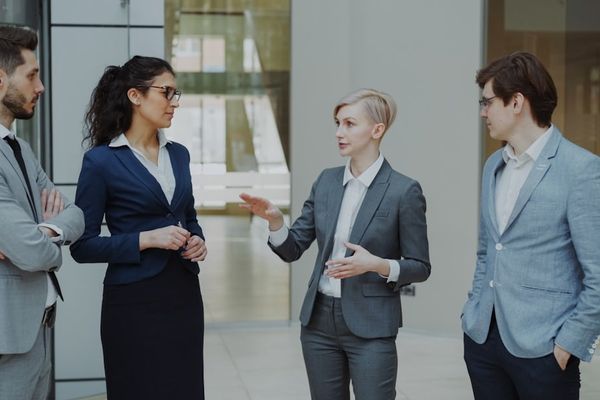 Four business professionals in a meeting discussing ideas.