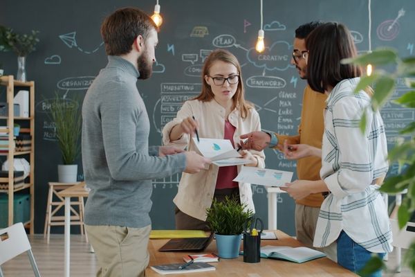 Colleagues collaborating around a table in an office.