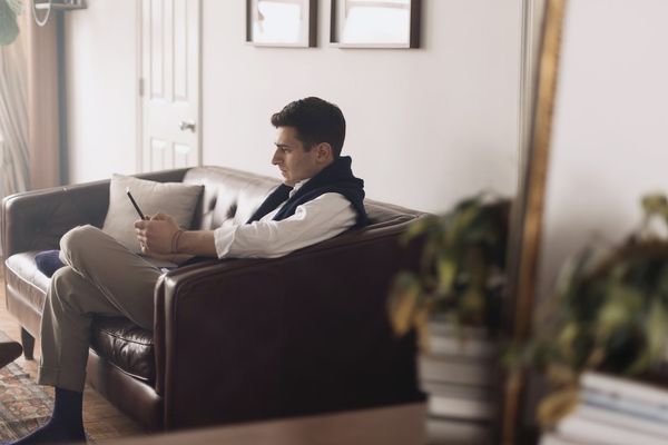 man sitting on brown couch
