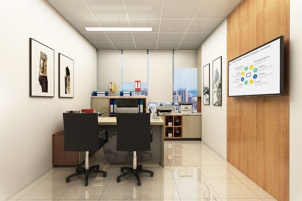 Modern office with desks, chairs, and a presentation screen.