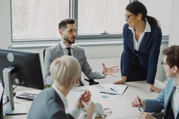 Business professionals collaborating in a modern office meeting.