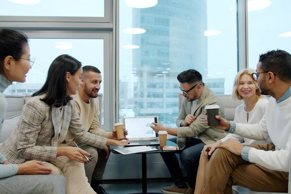 Diverse group of people in a modern office meeting.