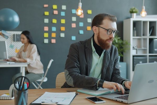Man and woman working in modern office setting.
