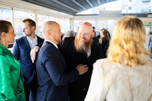 Two men with beards greeting each other warmly