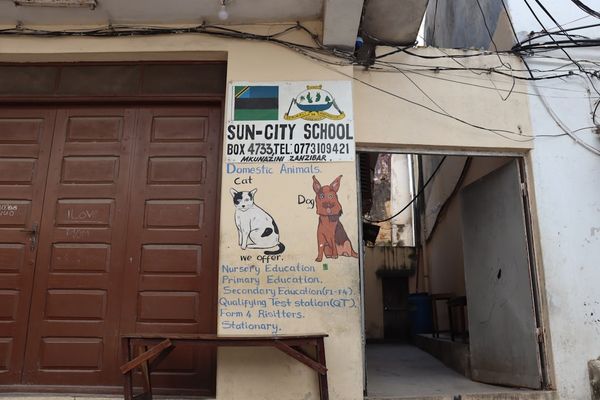 A building with two doors and a sign on the side of it