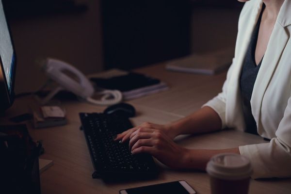 Woman working late at her office desk.
