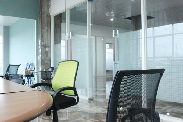 a conference room with a desk and chairs