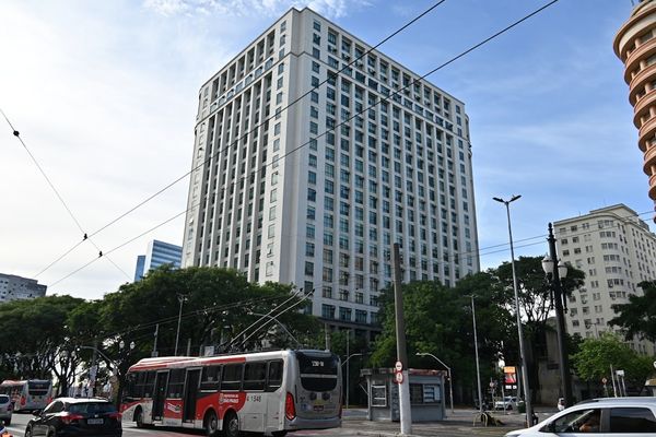 Modern tall office building with city traffic below