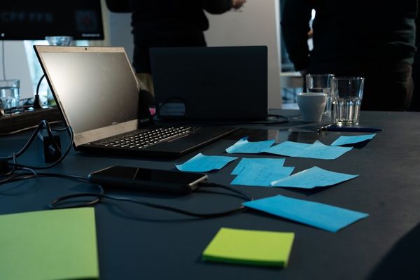 a table with sticky notes and a laptop on it