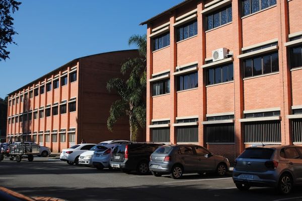 A parking lot with cars parked in front of a building