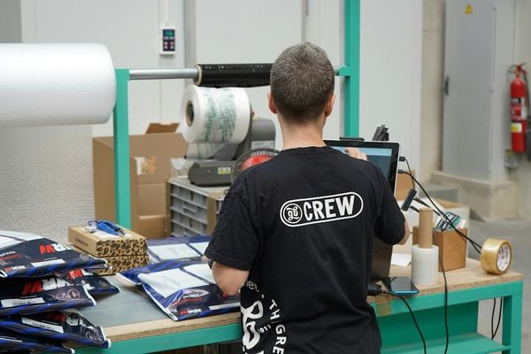 A man standing in front of a machine in a factory