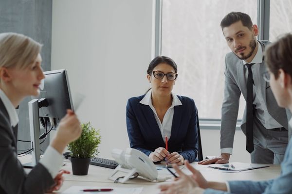 Business professionals collaborating in a modern office meeting.