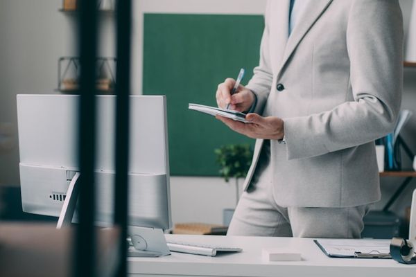 A man in a suit standing in an office