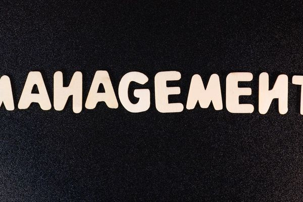 the word management written in white letters on a black background