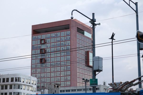 a tall red building sitting next to a traffic light