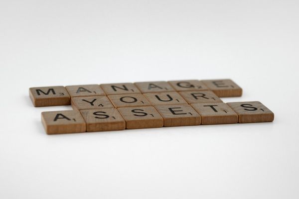 a couple of scrabble tiles sitting on top of each other