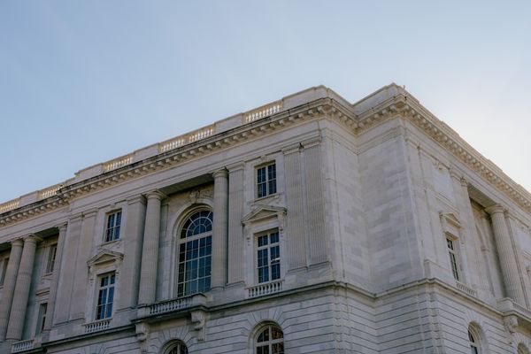A large white building with a sky background