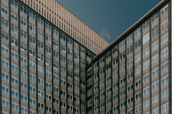 A couple of tall buildings sitting next to each other