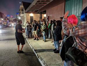 Guide leads a French Quarter Ghost Tour at night