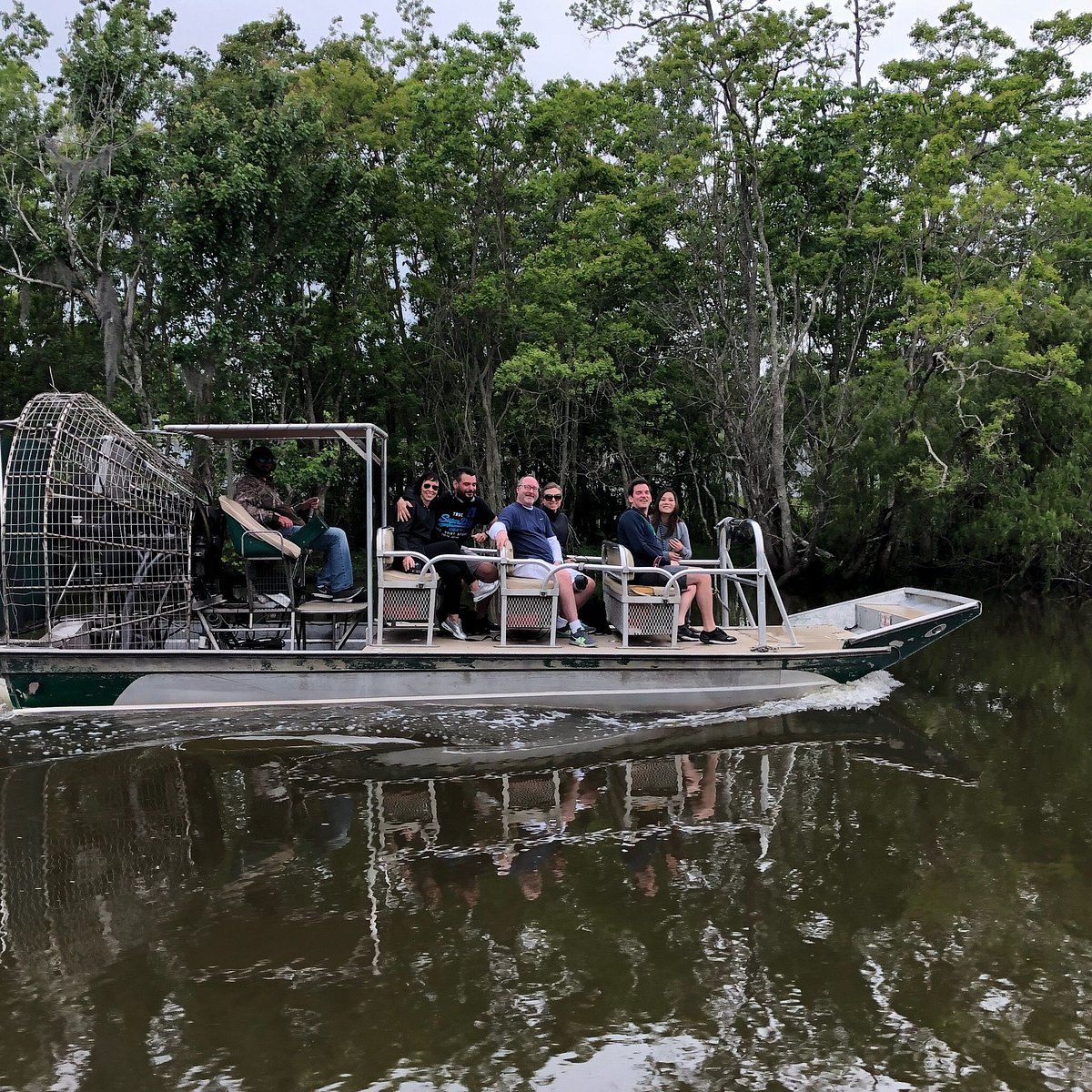 Happy guests smiling aboard small airboat swamp tour