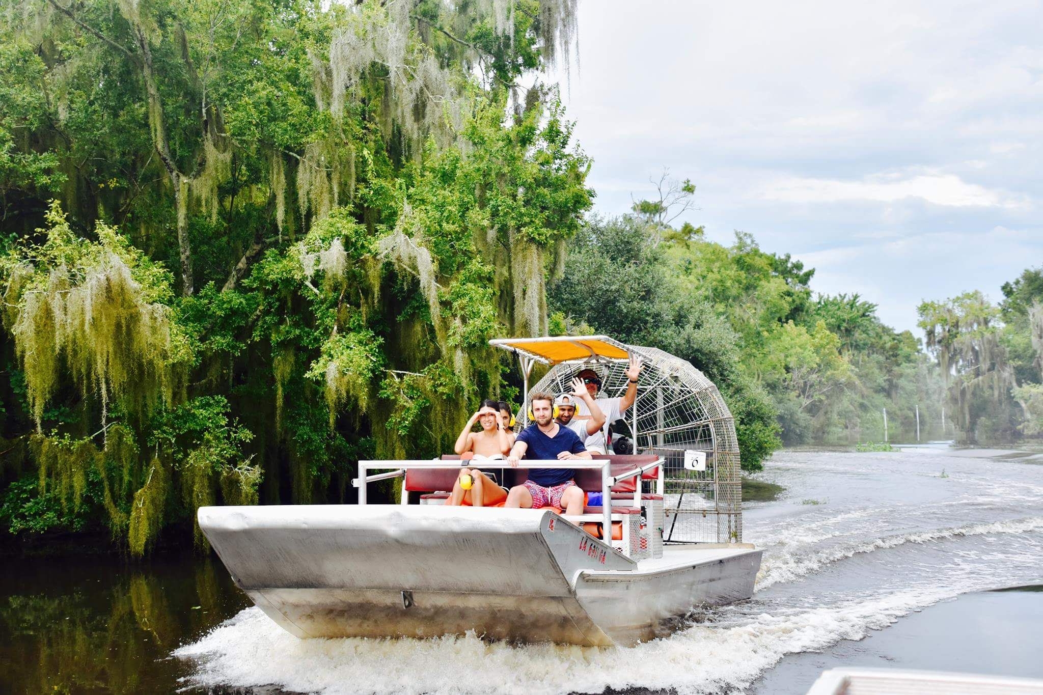 Premium small airboat gliding through scenic Louisiana cypress swamp